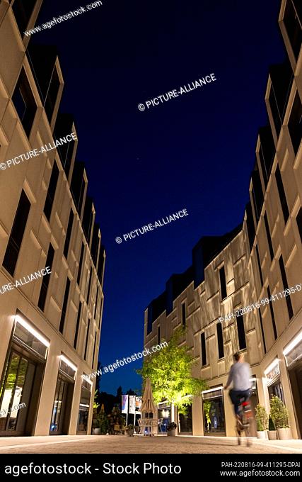 16 August 2022, Bavaria, Nuremberg: Dark blue is the evening sky at the blue hour above the buildings on the site ""Augustinerhof""
