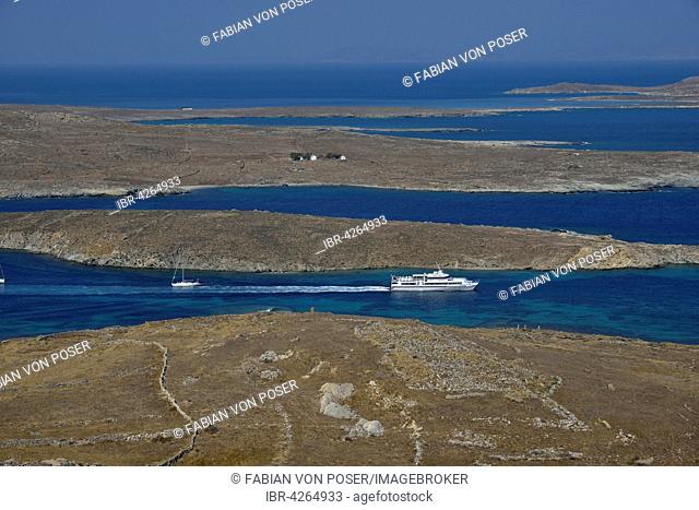 View over the island of Delos with an excursion boat, Cyclades, Greece