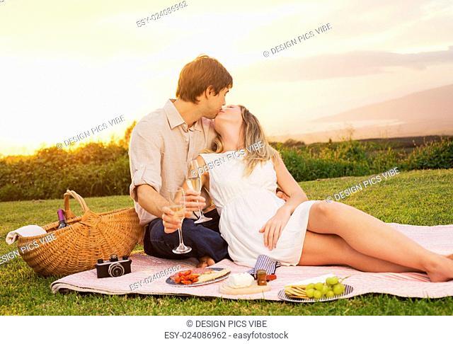 Attractive Couple Enjoying Romantic Sunset Picnic in the Countryside