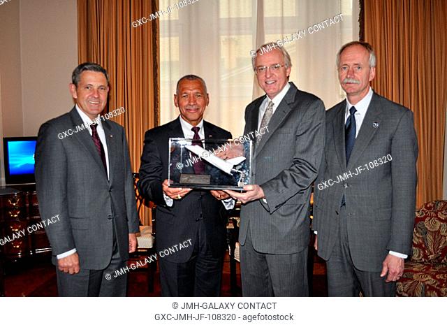 NASA Administrator Charles Bolden (second from left) presents a Space Shuttle model made of Shuttle tiles to the U.S. Ambassador to Russia