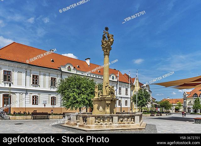 The Trinity Column in Baroque style was built in 1770. It is located in the main square Fo Ter in Keszthely. In the background is the town hall, Keszthely