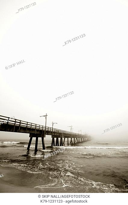 Pier at the beach on a cloudy day