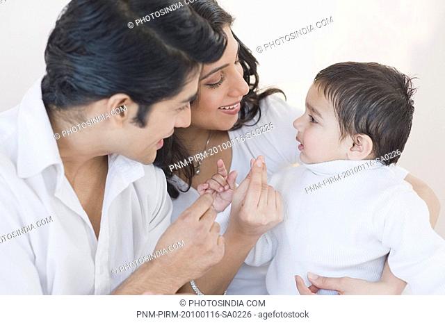 Couple playing with their son