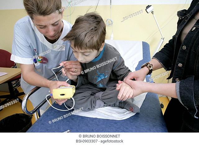 CHILD HOSPITAL PATIENT WITH NURSE Photo essay at the hospital of Meaux 77, France. Pediatric emergency department. Doctor and nurse with a child having...