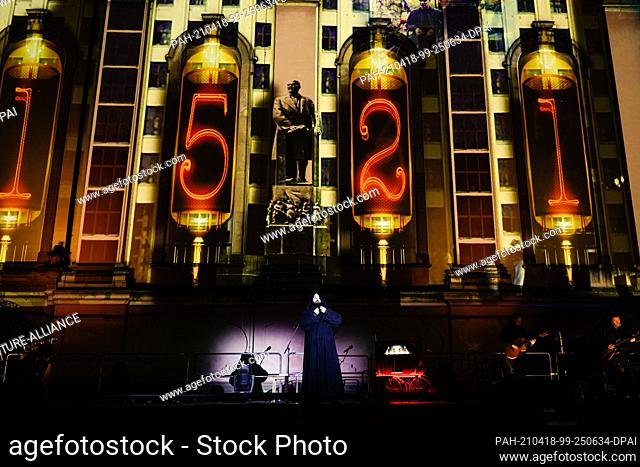 14 April 2021, Rhineland-Palatinate, Worms: Actor Isaak Dentler stands on stage in front of a light projection at the Dreifaltigkeitskirche during a media...