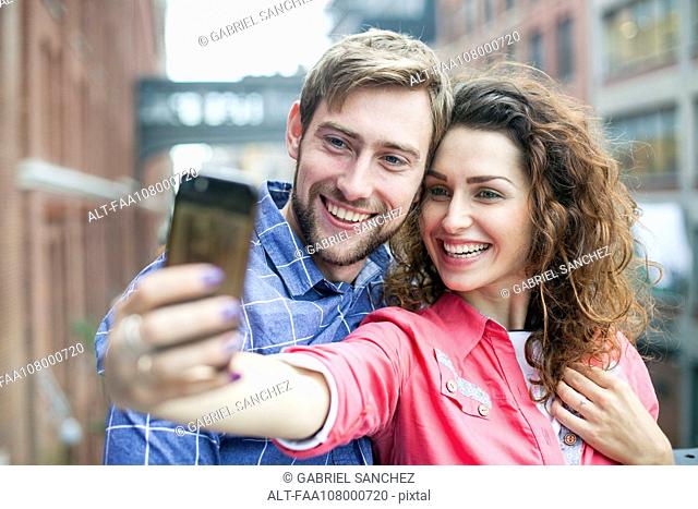 Couple taking a selfie together outdoors