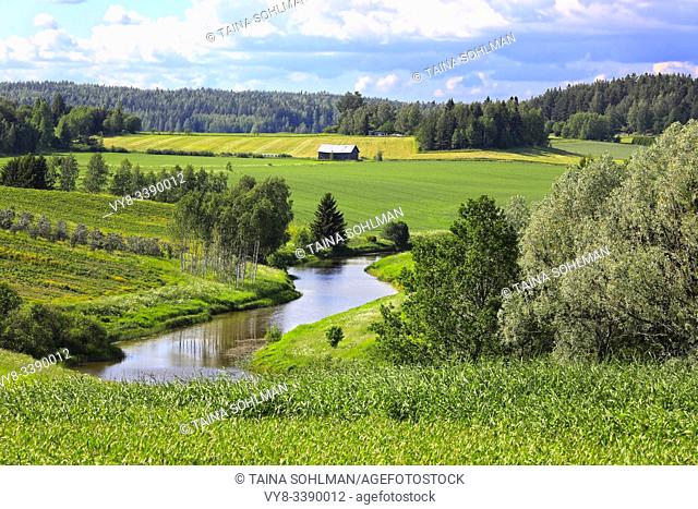 Rural landscape of a river valley and green fields on a beautiful day of summer. Halikko, Salo, Southwest of Finland