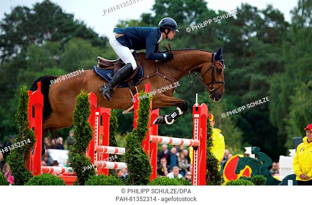 The French Maxime Livio jumps with on his horse Qalao des Mers over a hurdle at the four star tests of Eventing riders in Luhmuehlen, Germany, 19 June 2016
