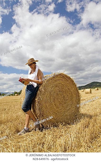Woman reading in field. Villarcayo. Burgos province, Castilla-León, Spain