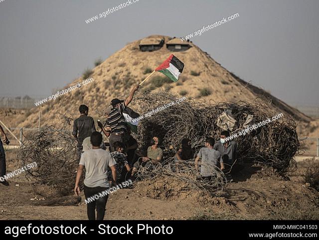 Palestinian demonstrators participate during a demonstration near the border between Israel and the Gaza Strip. A march organized by Palestinian factions on the...