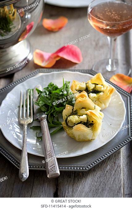Cheese and rocket puff pastry tartlets