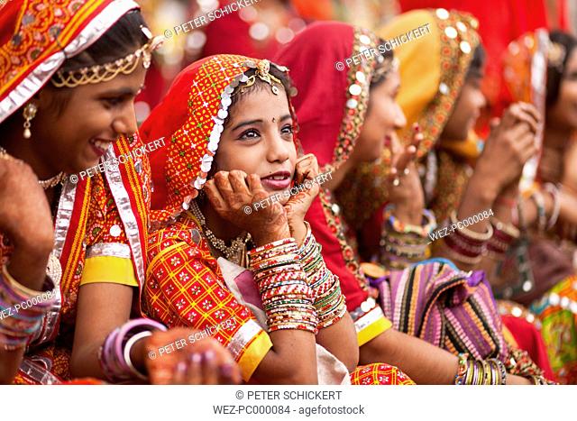 India, Rajasthan, Pushkar, young women at camel market Pushkar Mela wearing typical traditional clothing