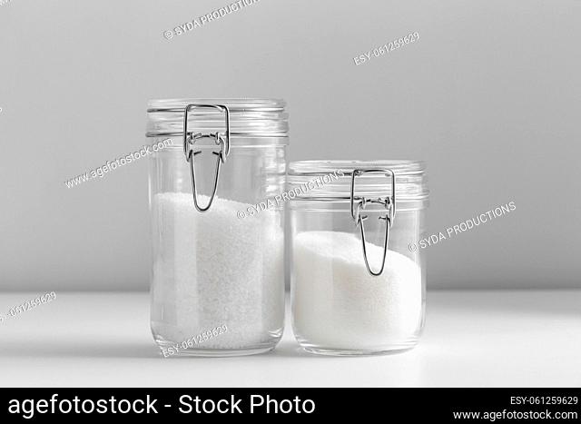 close up of white sugar and salt glass jars