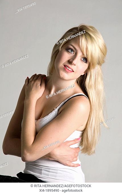 Young caucasian female giving herself a hug  She is looking up with aspiration attitude