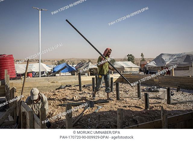 Syrian men build a shelter in the Ain Issa camp for internally displaced people (IDP) in Ain Issa, close to Raqqa, northern Syria, 19 July 2017