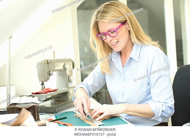 Smiling woman tailoring