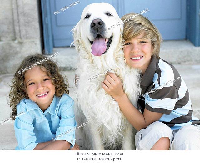 Brother and sister with their dog