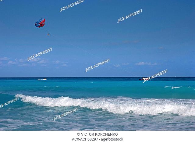 Tourists parasailing in Cancun, Mexico