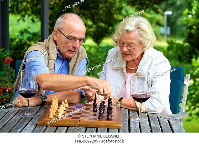 Senior couple on terrace playing chess