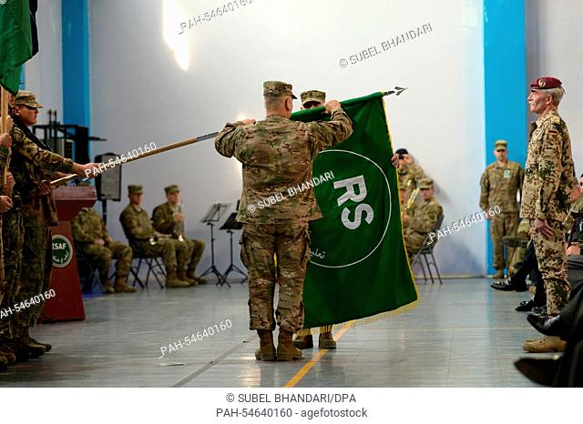 NATO-ISAF commander, General John Campbell and Command Sergeant Major Delbert Byers roll the ISAF flag during the casing of colour held at the coalition...