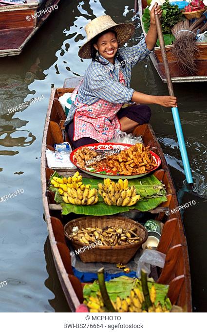 asian saleswoman with her boat at the Damnoen Saduak Floating Market, Thailand, Bangkok