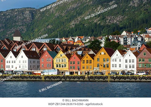 Bergen Norway Bryggen old town with famous wooden leaning houses and water at harbor pier at landmarks for tourists in BRYGGEN area scenic color