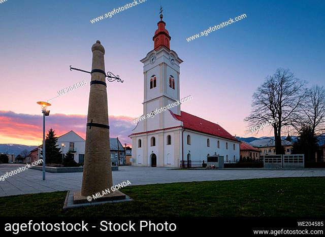Church and whipping post in the main square of Sucany, Slovakia