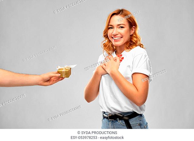 happy couple in white t-shirts with christmas gift