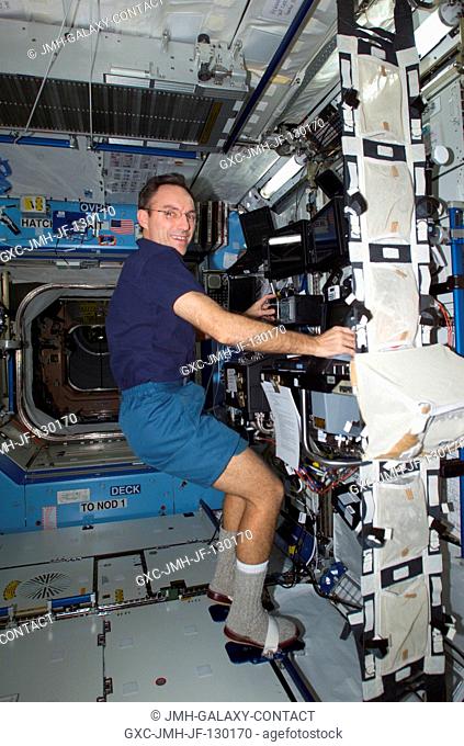 Astronaut Carl E. Walz, Expedition Four flight engineer, works the controls of the Canadarm2, or Space Station Remote Manipulator System (SSRMS) in the Destiny...