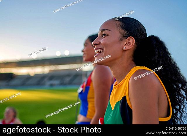 Happy female track and field athlete laughing
