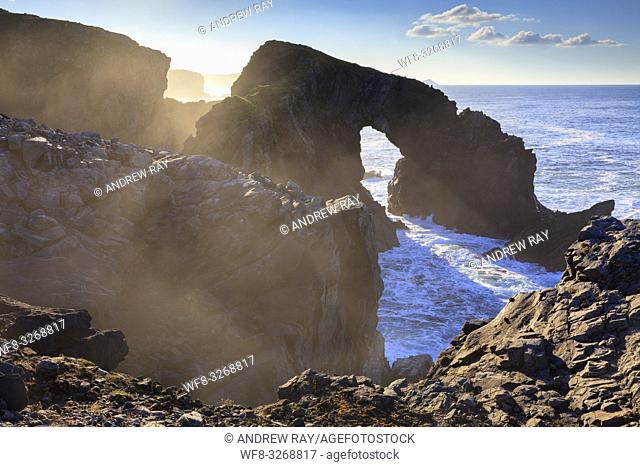 The natural sea arch at Stac a' Phris on the Isle of Lewis captured from the cliff top on an atmospheric afternoon in late October