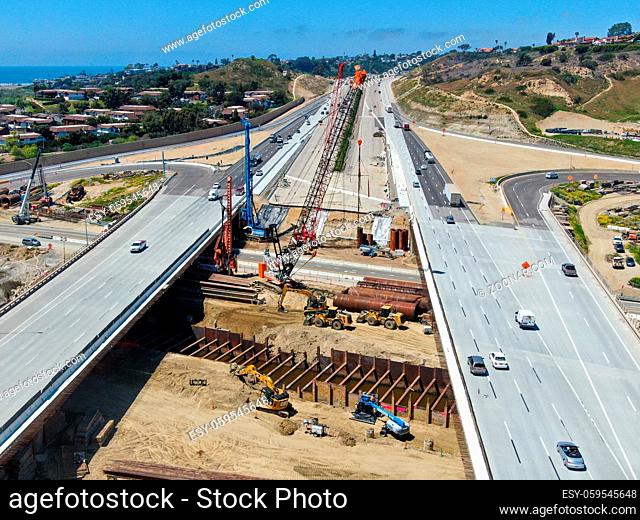 Aerial view of highway bridge construction over small river, San Diego, California, USA. Paril 18th, 2020