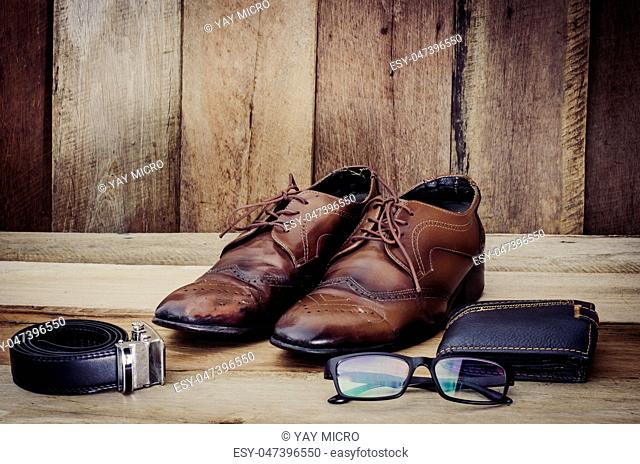Travel accessories, shoes, Belt, eyeglasses, wallet, ready for the trip on wood
