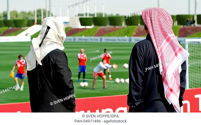 Men dressed in local traditional garb are seen during a training in Doha, Qatar, 13 January 2015. Bayern Munich stays in Qatar until 17 January 2015 to prepare...