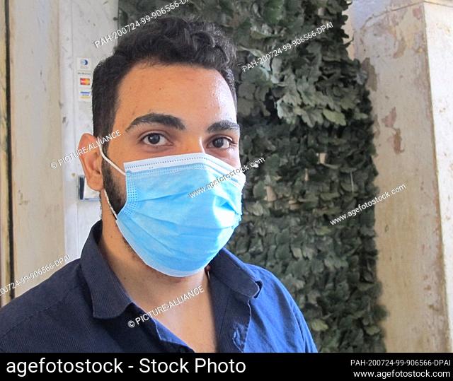 19 July 2020, Italy, Rom: Marco, a waiter in the restaurant ""La Locanda Romana"", stands with his mouth guard in front of the restaurant
