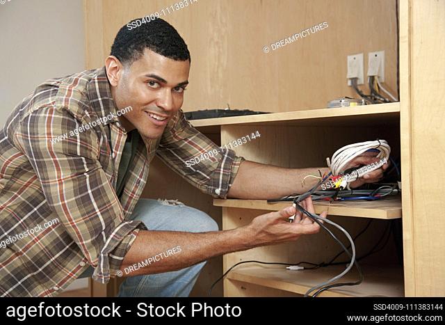 Mixed race man holding wiring