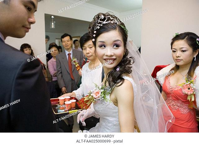 Chinese wedding tea ceremony, bride looking over shoulder