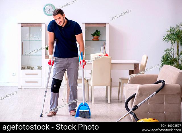 Young leg injured contractor cleaning house
