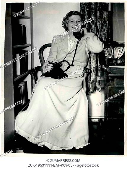 Nov. 11, 1953 - Royal Pilot's Home Raided - Twice. Mrs. Loraine Listews to the radio.: Mrs. Mary Loraine, wife of Captain A.C