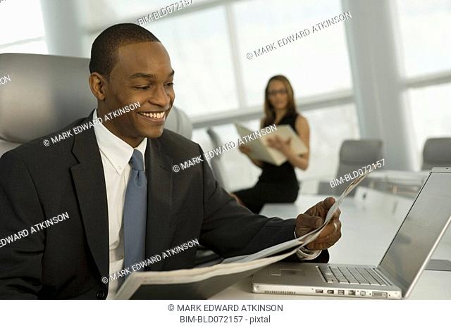 African business man reading newspaper