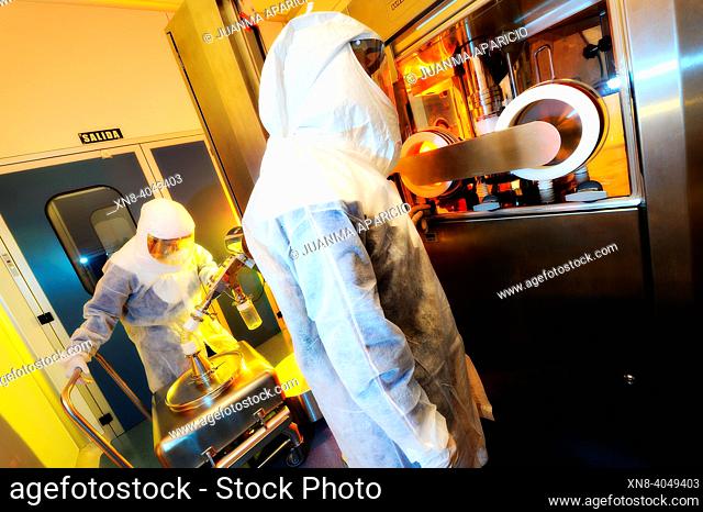 Laboratory technicians equipped with Security Suit inside a technology lab photographed with spectacular lighths