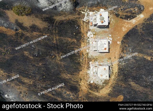 27 July 2023, Greece, Gennadi: Aerial photos from the village of Gennadi show the traces of the fire. But they also show the result of firefighting by...
