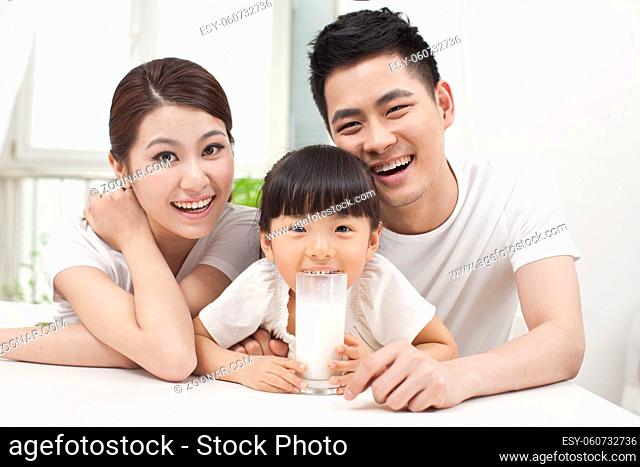 A happy family of three and milk high quality photo