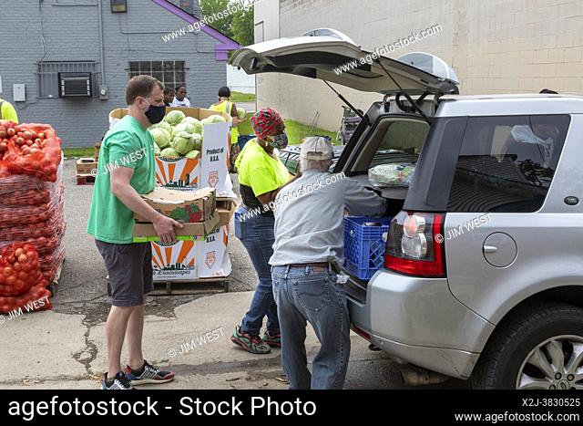 Detroit, Michigan - Volunteers in the Morningside neighborhood distribute free food in a low-income part of the city. The food was donated through the Gleaners...