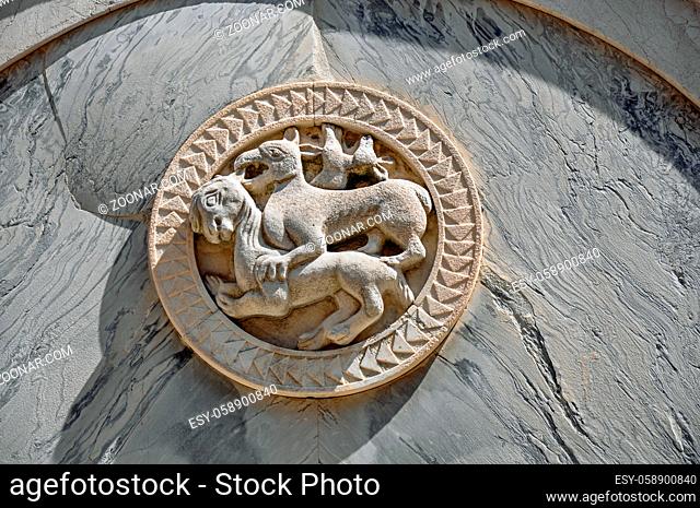 Close-up of embossed marble sculpture of animals on facade of old building in the city center of Venice, the historic and amazing marine city