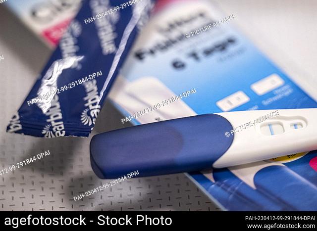 ILLUSTRATION - 12 April 2023, Berlin: An unwrapped positive pregnancy test is on the package. Photo: Hannes P. Albert/dpa. - Berlin/Berlin/Germany