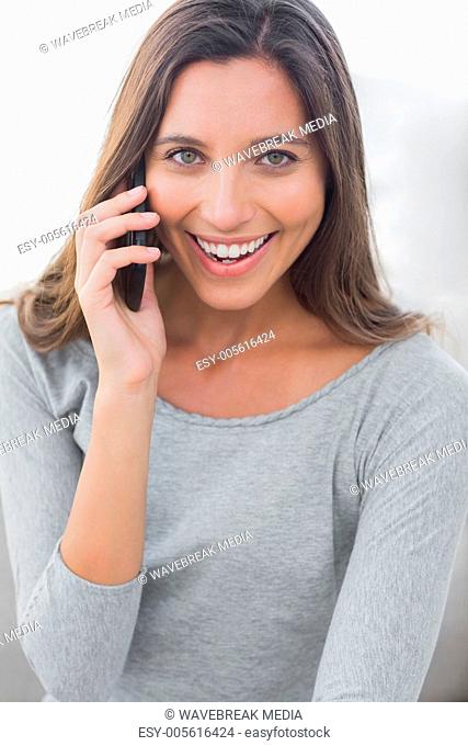 Pretty woman laughing while she is on the phone