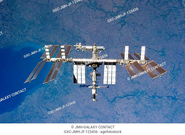 The International Space Station is featured in this image photographed by an STS-131 crew member on space shuttle Discovery after the station and shuttle began...