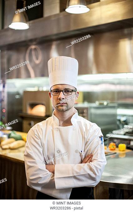 A portrait of a Caucasian male chef in a commercial kitchen