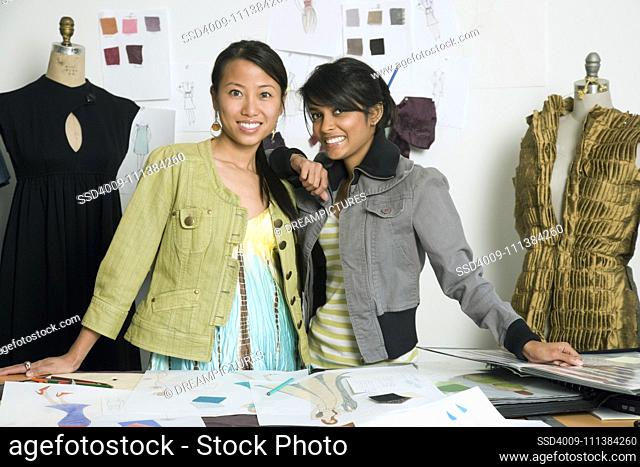 Multi-ethnic female fashion designers in workshop